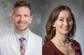 Dr. Christopher Lunsford (left) wears his white coat and a salmon and blue plaid tie with a light blue shirt. Marion Quirici (right) wears a dark red shirt and pearls on her neck. Dr. Christopher Lunsford (left) wears his white coat and a salmon and blue plaid tie with a light blue shirt. Marion Quirici (right) wears a dark red shirt and pearls on her neck.